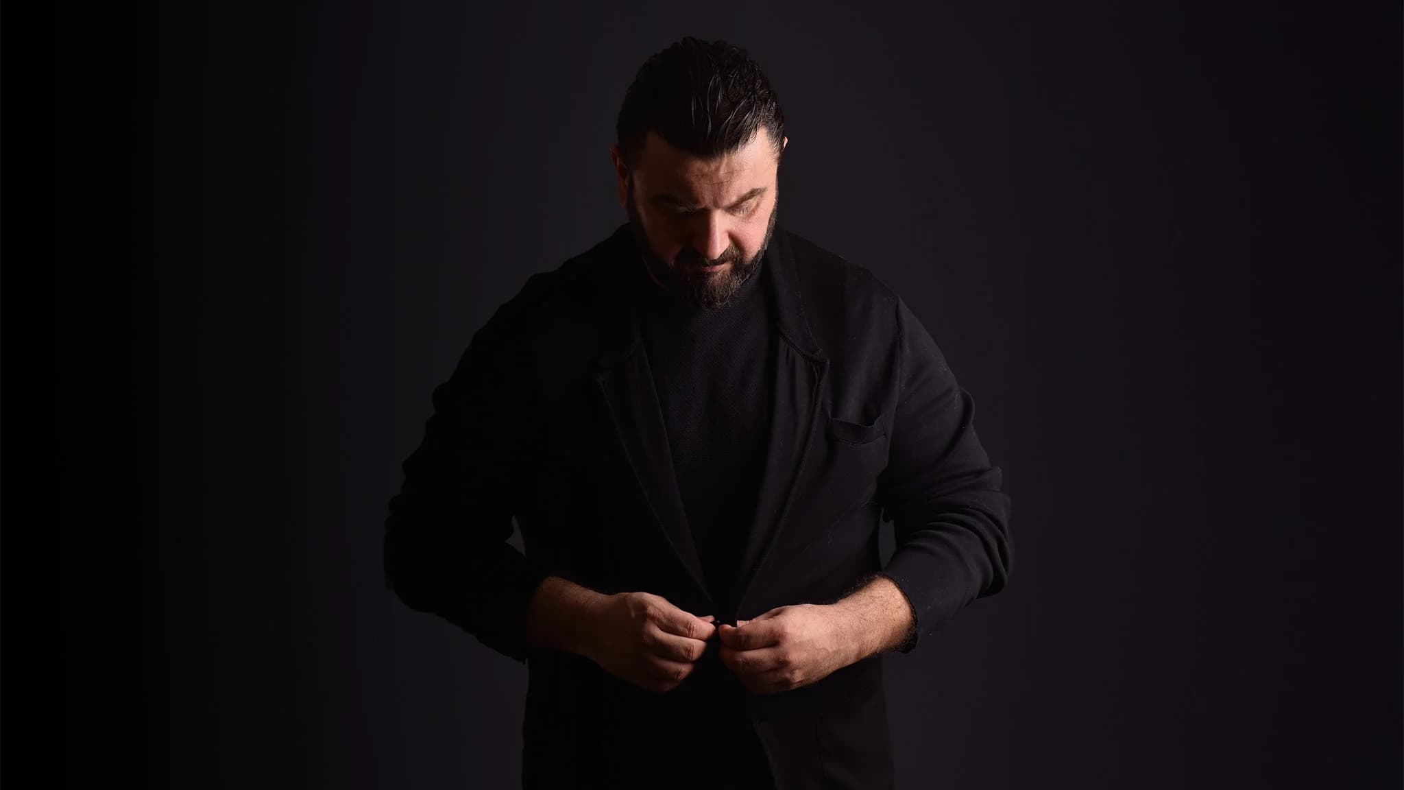 Volkan Uçak, siyah gömlekli portre